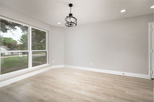 Empty room with a chandelier, light wood-type flooring, and recessed lighting | Image 26