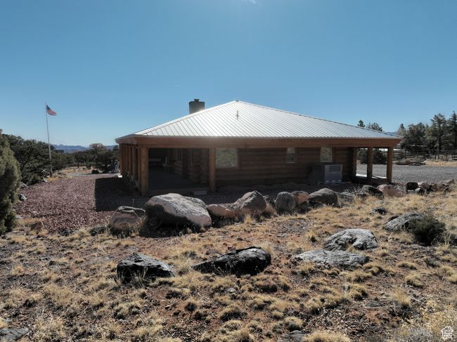 View of side of property with a chimney, central AC, and metal roof | Image 21