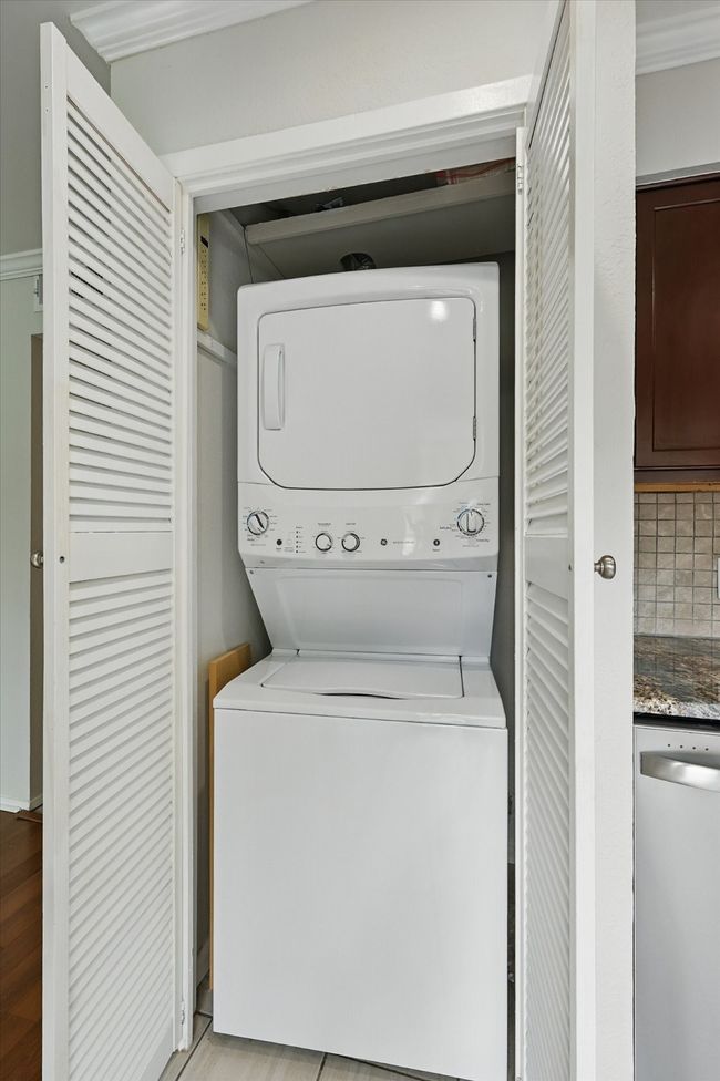 Laundry area featuring stacked washer / dryer | Image 11