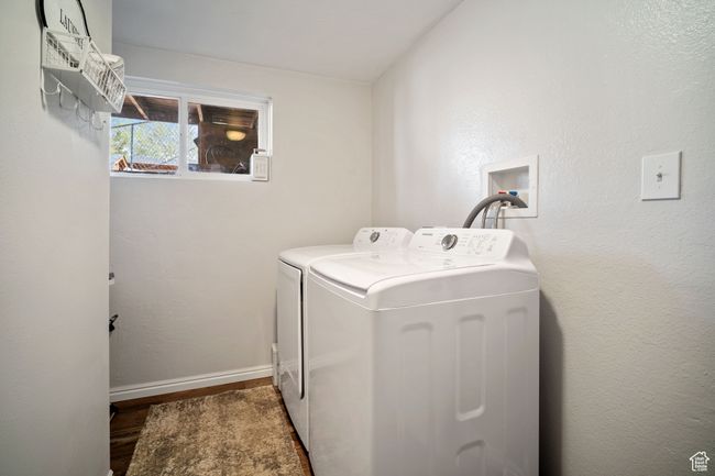 Laundry room featuring washing machine and clothes dryer, wood finished floors, laundry area, and baseboards | Image 20