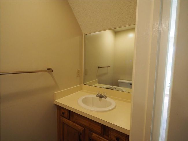 Bathroom with vanity, lofted ceiling, toilet, and a textured ceiling | Image 4
