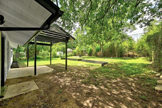 Fenced backyard featuring a patio area | Image 24