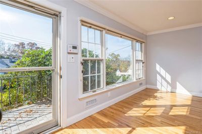 Living room Doorway to outside with light hardwood / wood-style floors and crown molding | Image 2