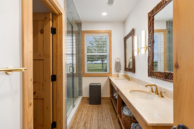 Full bathroom featuring double vanity and a stall shower | Image 23