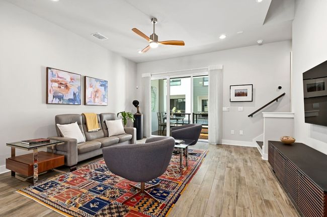 Living room on the main floor opens directly to a balcony. | Image 11