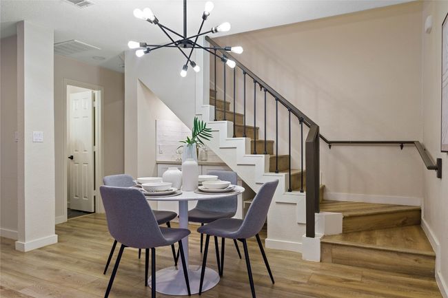 Dining space featuring stairs, an inviting chandelier, wood finished floors, and baseboards | Image 17