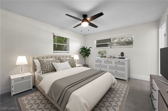 Bedroom featuring ceiling fan and dark tile patterned floors | Image 26