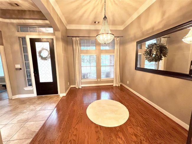 Formal dining at its best! Wood flooring with an elegant chandelier that would beautify any table setting. | Image 5