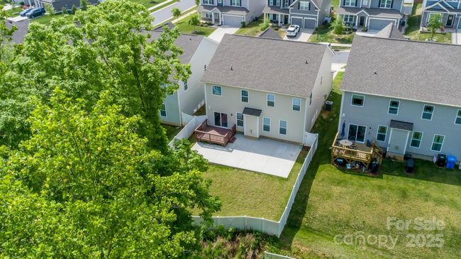 Beautiful tree lined fenced yard with deck and extended patio | Image 37