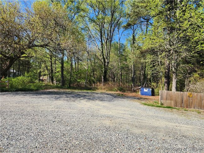 Ample parking in the rear of the building. Graveled drive and parking area. | Image 8