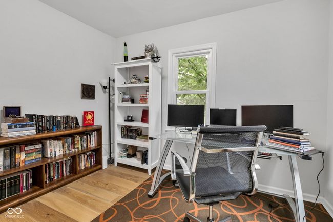 Main floor bedroom utilized as office space. | Image 22