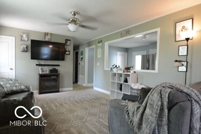sitting room featuring carpet flooring and baseboards | Image 11