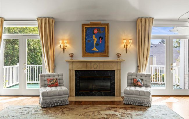 Sitting room with french doors, a fireplace, and wood finished floors | Image 7