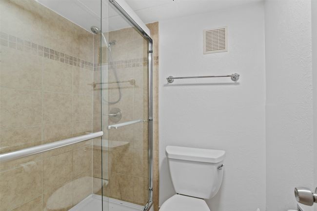 Upstairs ensuite bathroom with custom tile shower. | Image 23