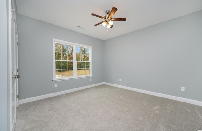 Spare room with light colored carpet and ceiling fan | Image 9