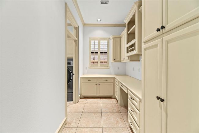 Workroom adjacent to laundry room. | Image 26