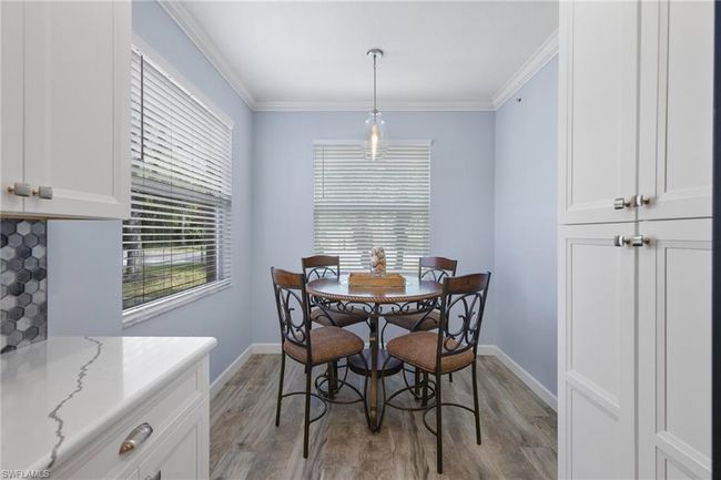 Dining room featuring crown molding and light hardwood / wood-style flooring | Image 7