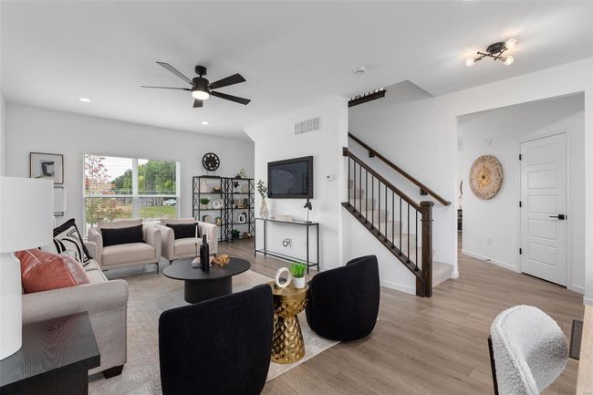Living room featuring light hardwood / wood-style flooring and ceiling fan | Image 4