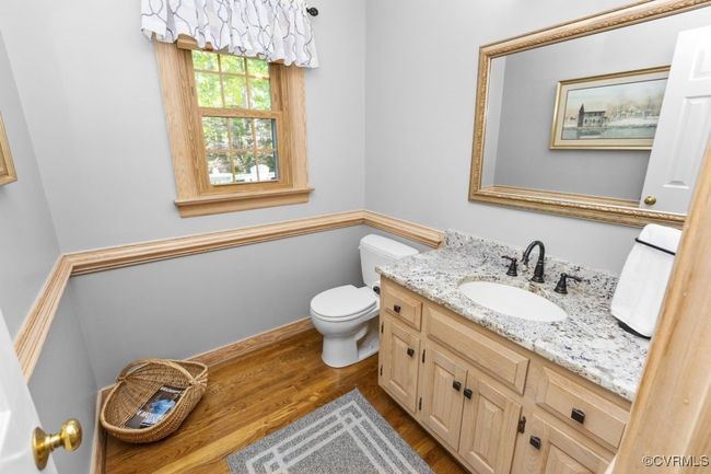 Bathroom with wood finished floors, vanity, and toilet | Image 22