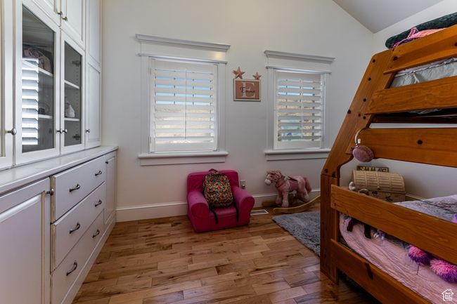 Bedroom featuring baseboards, lofted ceiling, and light wood-style flooring | Image 20