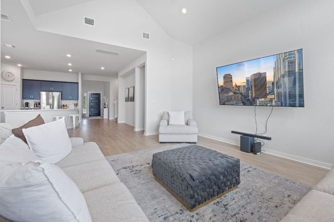 Living room with light wood-style floors, visible vents, and recessed lighting | Image 9