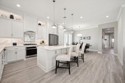 Gorgeous culinary dream with quartz countertops and marble backsplash. | Image 3