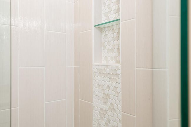 Walk-in floor to ceiling ceramic tile shower seen in the primary bathroom | Image 22