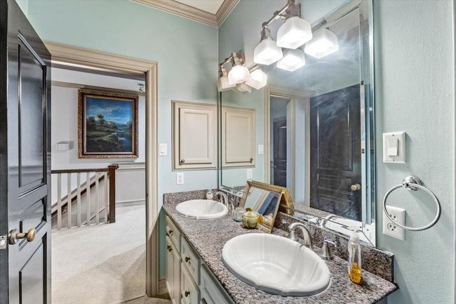 Shared by the second and third bedrooms, this second full bathroom blends timeless sophistication with the relaxed elegance of a coastal retreat, perfect for family and guests alike. | Image 39