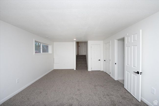 Below grade area featuring stairway, baseboards, and carpet | Image 28