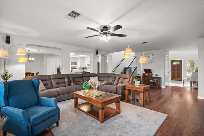 This home has two living areas. First living area is large N is open to the kitchen. The stair way has an entrance on both sides of the foyer and the living area. | Image 8