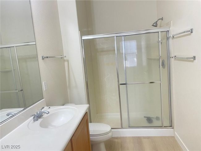 Full bath with a shower stall, vanity, and wood finished floors | Image 23