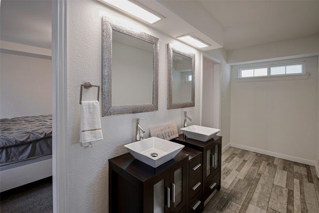 Full bath with connected bathroom, double vanity, and wood finished floors | Image 18