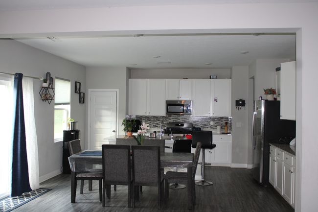 dining room featuring dark wood-type flooring and baseboards | Image 5