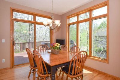 Large informal dining area in the kitchen with stunning nature views. | Image 3