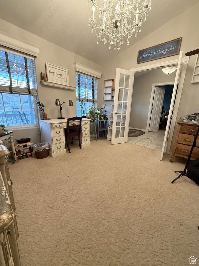 Office space with a healthy amount of sunlight, vaulted ceiling, french doors, and a chandelier | Image 7