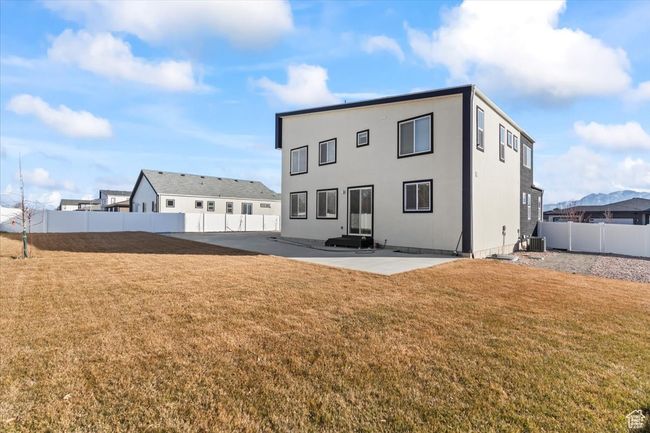 Rear view of property with a lawn, a fenced backyard, a patio, and central AC unit | Image 27