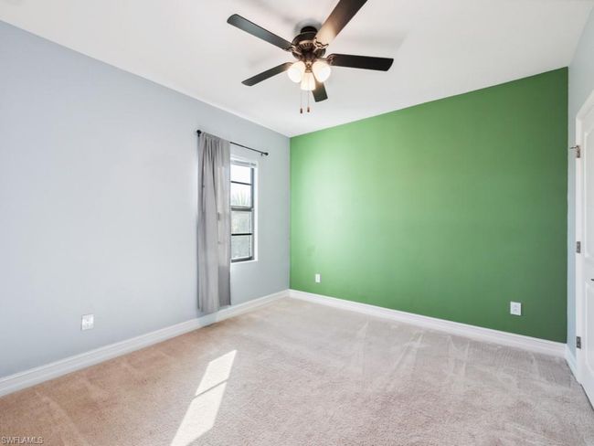 Carpeted spare room featuring ceiling fan | Image 12
