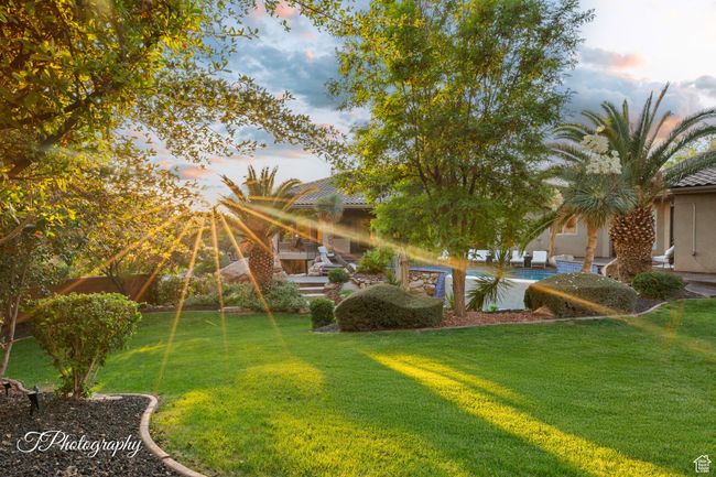 Yard at dusk with a lawn and an outdoor pool | Image 50