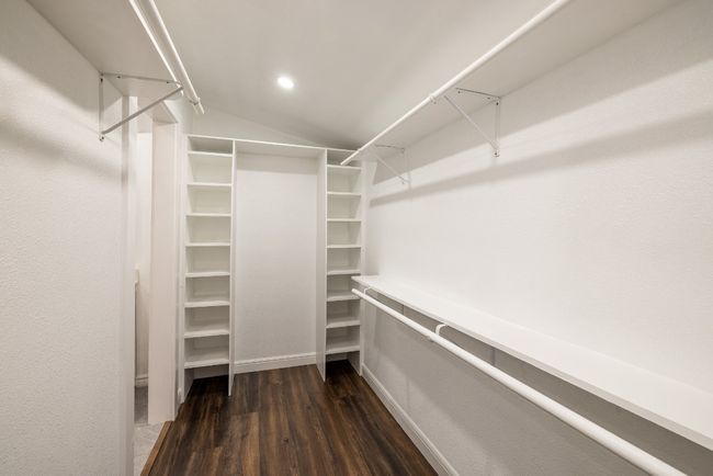 Spacious closet featuring dark wood-type flooring and lofted ceiling | Image 16