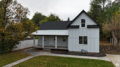 View of front of house with a front yard and a porch | Image 1