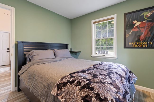 Bedroom with wood finished floors and baseboards | Image 6