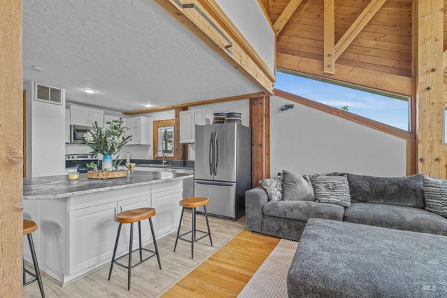Living room featuring light wood-style flooring, recessed lighting, and a textured ceiling | Image 7