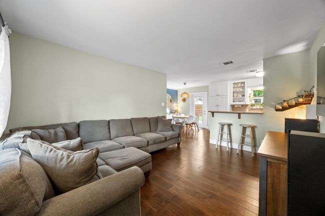 Living area with dark wood-style flooring | Image 4