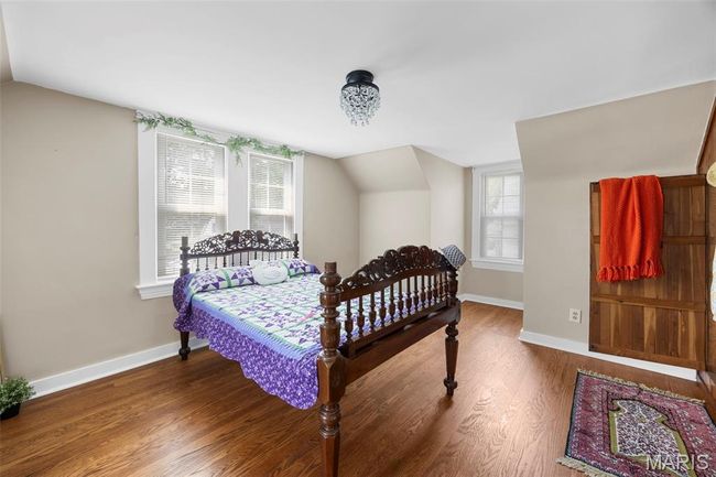 Bedroom featuring lofted ceiling and wood finished floors | Image 19