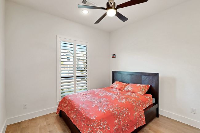 Bedroom with multiple windows, wood finished floors, baseboards, and recessed lighting | Image 27