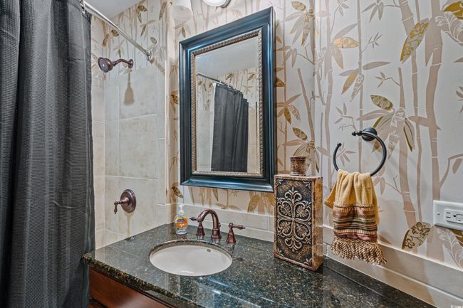 Full bath featuring vanity, a shower with curtain, and wallpapered walls | Image 24