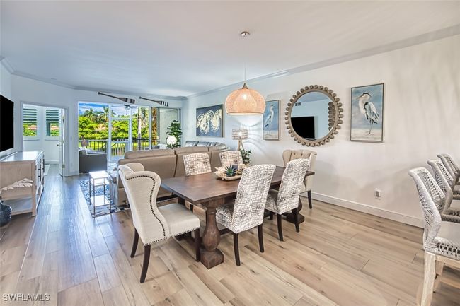 Dining room with light wood-type flooring and crown molding | Image 16
