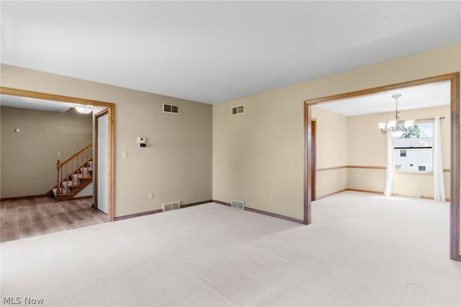 Spare room with hardwood / wood-style flooring and a chandelier | Image 7