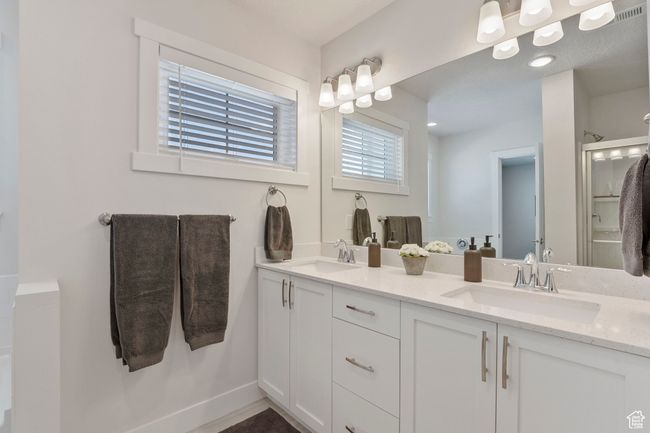 Bathroom with double vanity and a shower with shower door | Image 15