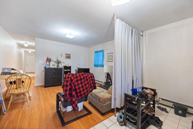Living area featuring a baseboard radiator and light wood-type flooring | Image 31